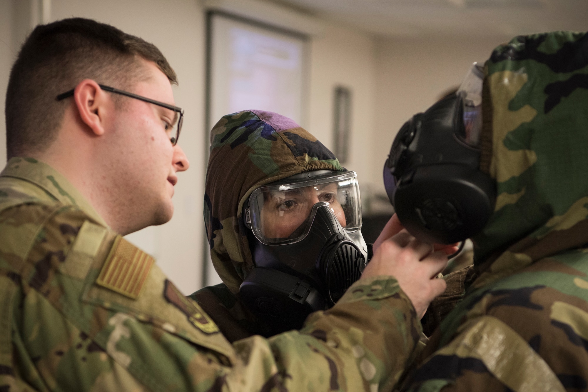 U.S. Air Force Senior Airman Richard Blackburn, 773d CES Emergency Management chemical, biological, radiological and nuclear (CBRN) instructor shows Tech. Sgt. Kasama Slaton, 673d Medical Operations Squadron, how to identify exposures risks to Senior Airman Kolbe Kleinschnitz, 3rd Maintenance Squadron, during a newly-implemented CBRN defense training course at Joint Base Elmendorf-Richardson, Alaska, Jan. 8, 2019. One of the key changes made embraces the reintegration of hands-on, in-person instruction, and reduces computer based training, allowing Airmen to receive a more tailored learning experience. (U.S. Air Force photo by Airman 1st Class Crystal A. Jenkins)