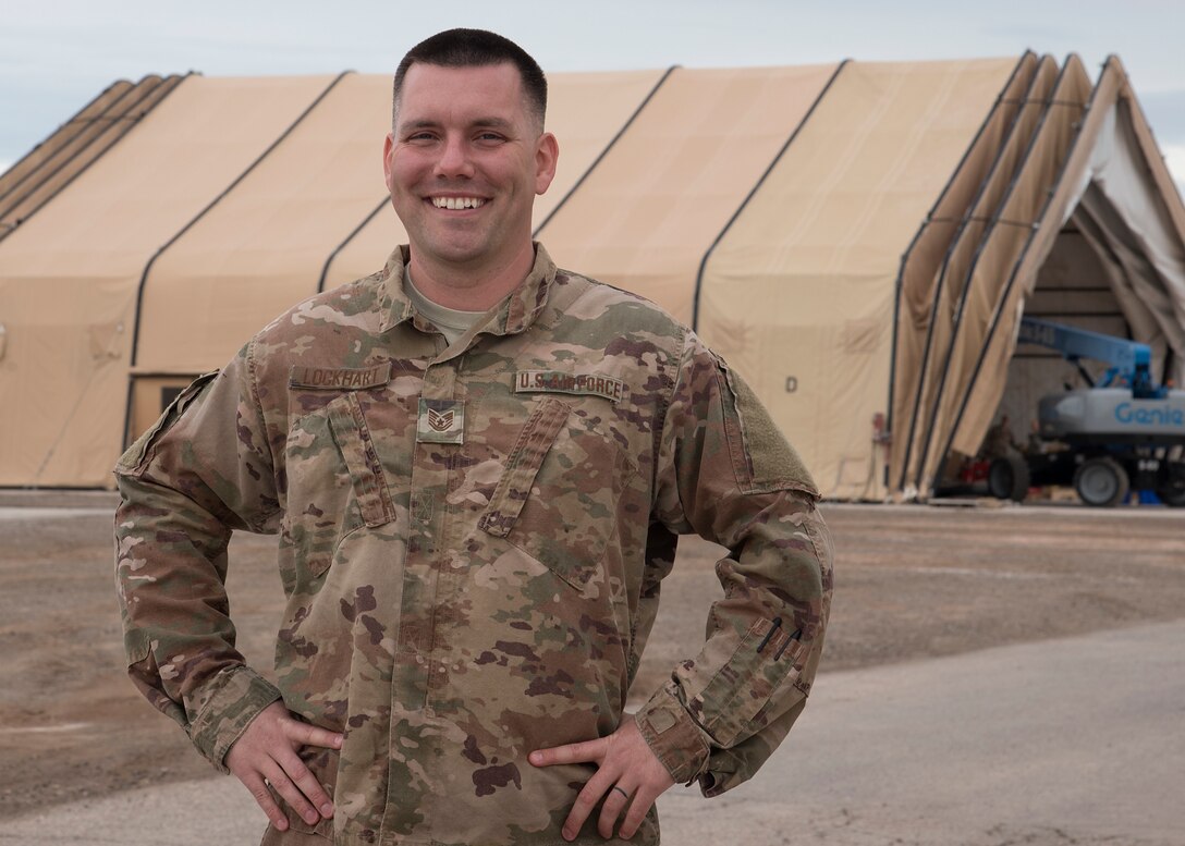 Tech. Sgt. Dustin Lockhart, 635th Material Maintenance Squadron metals technologist, poses for a personality portrait in front of a large area mission structure Jan. 9. 2019, on Holloman Air Force Base, N.M. Lockhart works side by side with Airmen trained in many areas to build LAMS, such as housing and hospitals, for deployed environments. (U.S. Air Force photo by Airman 1st Class Kindra Stewart)