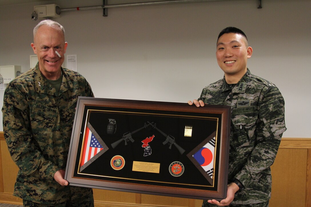 CAMP HUMPHREYS, Republic of Korea – Maj. Gen. Patrick J. Hermesmann, U.S. Marine Corps Forces Korea commander, presents Capt. Jaewon Choi, Republic of Korea Marine Corps liaison officer to the U.S. Marine Corps, a token of appreciation for his work with MARFORK here, Jan. 8. Choi’s job at MARFORK was a vital link between the unit and the R.O.K. Marine corps and served to strengthen the alliance between the services and countries alike. (Official U.S. Marine corps photo by Sgt. Nathaniel Hanscom)