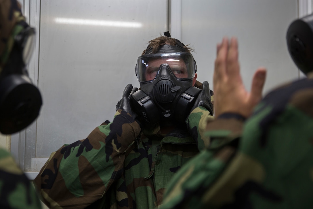 A Marine with the 31st Marine Expeditionary Unit clears his protective mask during Chemical, Biological, Radiological, Nuclear defense training at Camp Hansen, Okinawa, Japan, Jan. 4, 2019. CBRN training test Marines abilities to respond in the event of chemical, biological, radiological or nuclear contamination. The 31st MEU, the Marine Corps’ only continually forward-deployed MEU, provides a flexible and lethal force ready to perform a wide range of military operations as the premier crisis response force in the Indo-Pacific region. (U.S. Marine Corps photos by Lance Cpl. Cameron Parks/ Released)