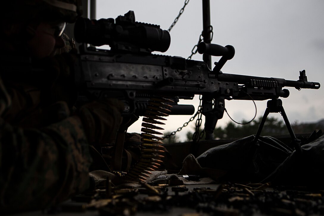 Pfc. Trenton Jones, a machine gunner with Charlie Company, Battalion Landing Team, 1st Battalion, 4th Marines, fires an M240B medium machine gun during training at Camp Hansen, Okinawa, Japan, Jan. 9, 2019.