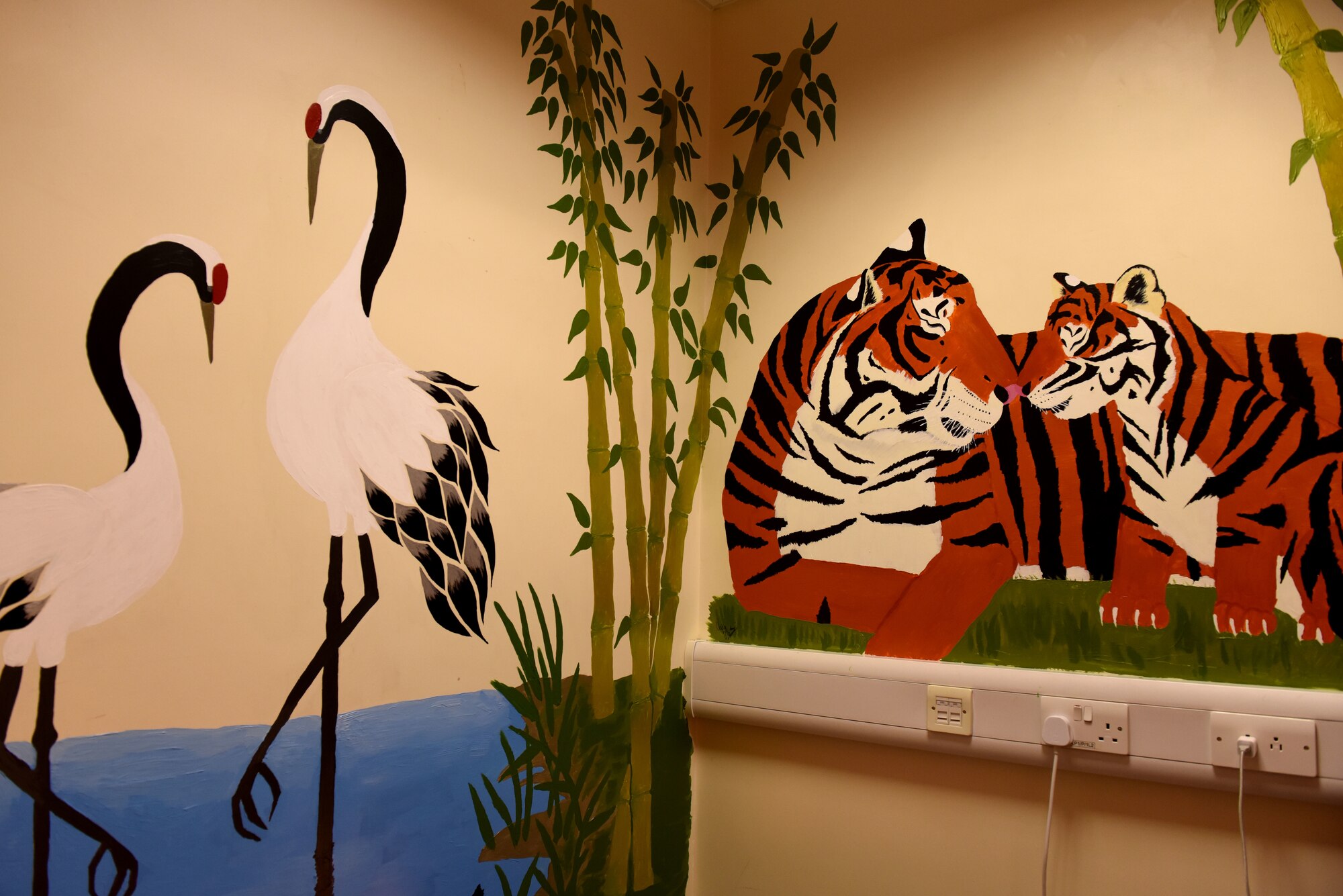 A children’s picture book-themed mural is painted on the walls of the Mothers’ Room in the 100th Communications Squadron building at RAF Mildenhall, England, Jan. 7, 2019.  Volunteer Nadja Ellis painted the mural to create a tranquil space for new mothers to breastfeed.   (U.S. Air Force photo by Senior Airman Lexie West)