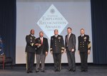 DLA Director Army Lt. Gen. Darrell Williams, left, DLA Troop Support Commander Army Brig. Gen. Mark Simerly, center, and Navy Command Master Chief Shaun Brahmsteadt (far right) present Roberto Santana Irizarry, second left, contracting officer representative, DLA Troop Support Subsistence supply chain, with the DLA Leader of the Year award during the 51st Annual Employee Recognition Awards Ceremony, Dec. 13, 2018 at the McNamara Headquarters Complex Auditorium, Ft. Belvoir, Va. Santana Irizarry received the award for his significant achievements in providing logistical support to the Warfighter throughout Afghanistan.