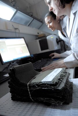 Uraina Gray-Scully (left) and Ardra Farally, color scientists with DLA Troop Support’s Product Test Center-Analytical, examine the results of a test run on incoming fabric from the manufacturer. Product lot testing is required for all uniform items to ensure the vendor is meeting the fabric quality and color specifications so service members’ clothing is uniform.