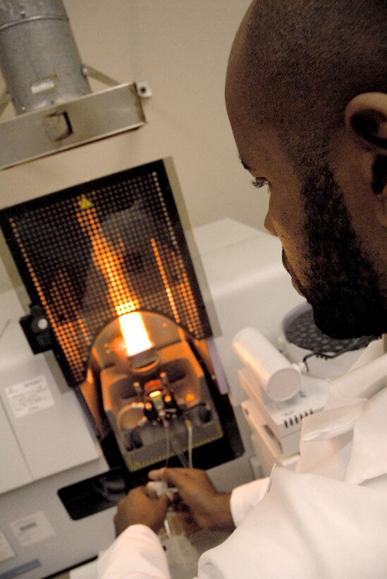 Andres Aquino, a Product Test Center-Analytical scientist, tests a metal sample in the atomic absorption spectrophotometer. PTC-A scientists use this equipment to analyze the concentration of elements in a liquid sample based on energy absorbed from certain wavelengths of light.