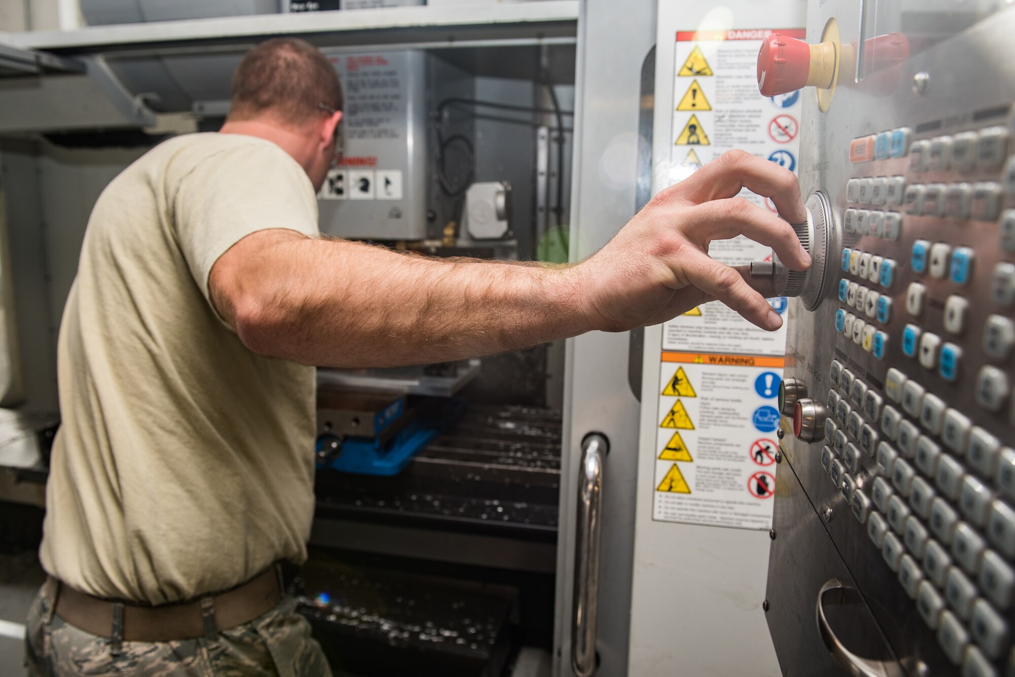 Staff Sgt. Tyler Dickson, 512th Maintenance Squadron aircraft metal technician, programs a vertical mill computer numeric system at Dover Air Force Base, Delaware, Jan. 6, 2019. Dickson utilized the vertical mill CNC to engineer a cradle plate for a HH-60G Pave Hawk helicopter.  (U.S. Air Force photo by Staff Sgt. Damien Taylor)