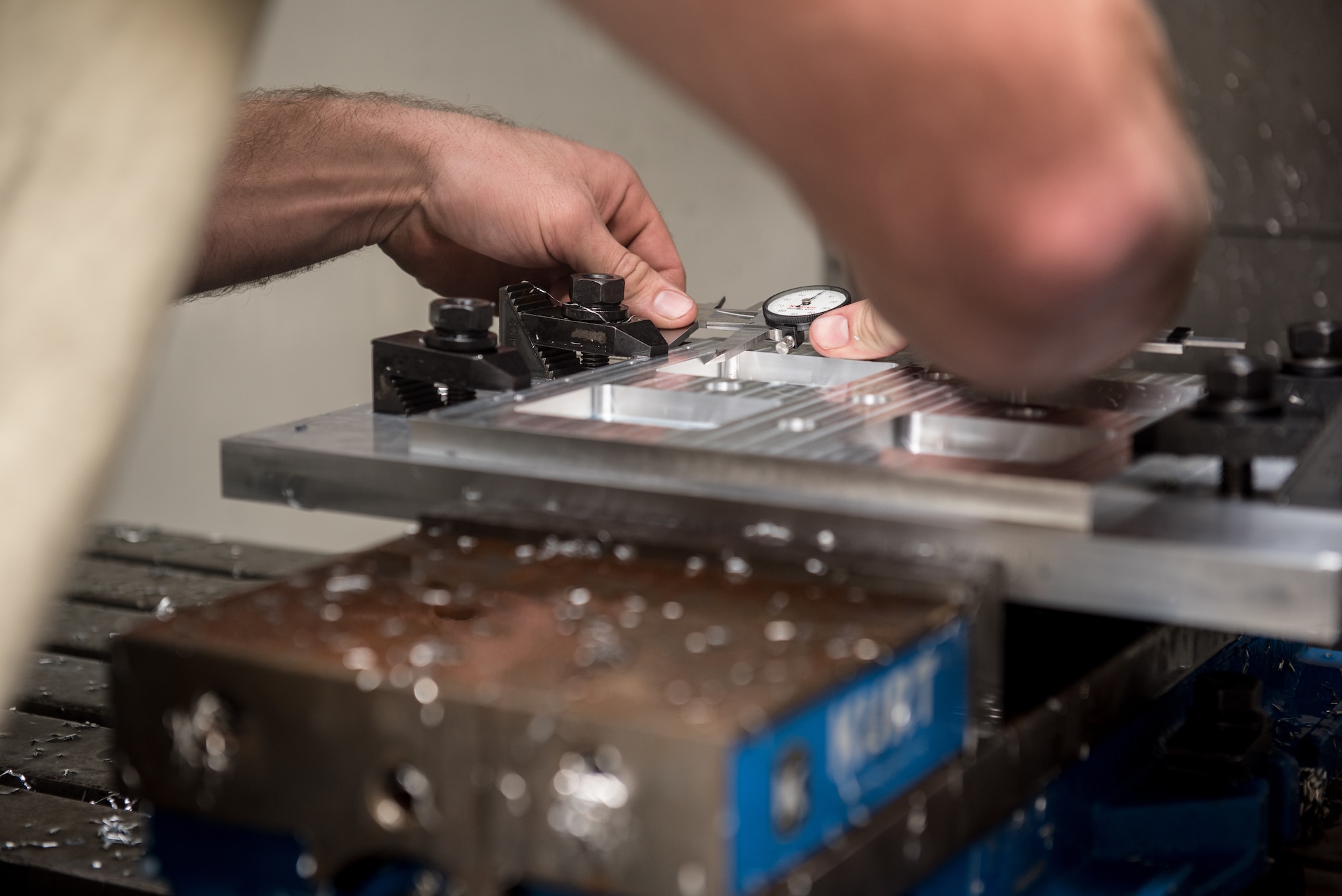 Staff Sgt. Tyler Dickson, 512th Maintenance Squadron aircraft metal technician, measures drill holes on an aluminum plate at Dover Air Force Base, Delaware, Jan. 6, 2019. Dickson utilized the vertical mill computer numeric system to engineer a replica of one of three  sample plates needed for a HH-60G Pave Hawk helicopter. (U.S. Air Force photo by Staff Sgt. Damien Taylor)