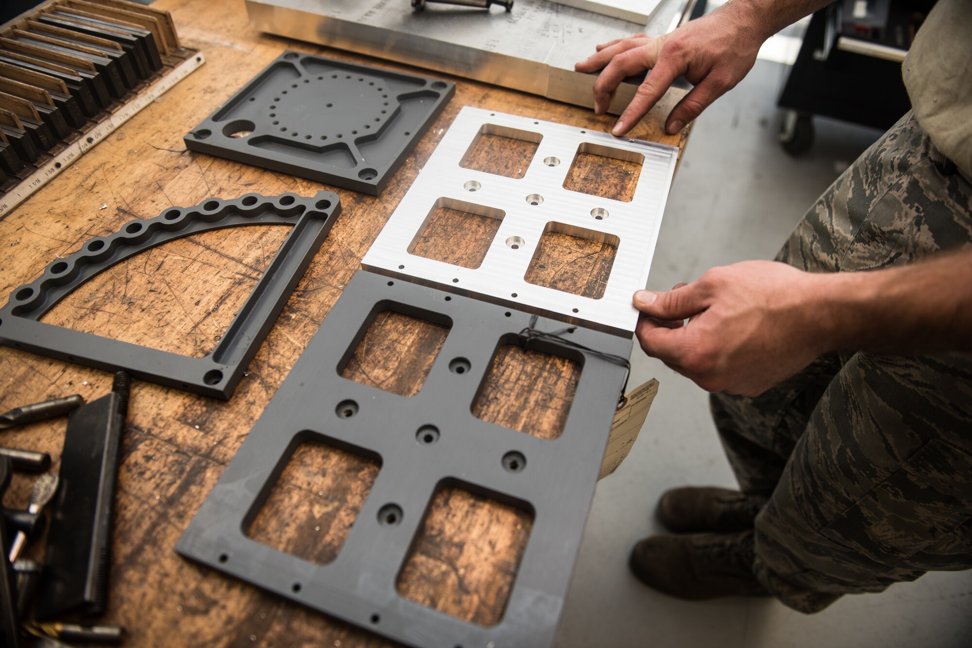 Staff Sgt. Tyler Dickson, 512th Maintenance Squadron aircraft metal technician, inspects HH-60G Pave Hawk plates at Dover Air Force Base, Delaware, Jan. 6, 2019. The 512th MXS plans to manufacture four replicas of each plate to ship to the 920th Rescue Wing at Patrick AFB, Florida. (U.S. Air Force photos by Staff Sgt. Damien Taylor)