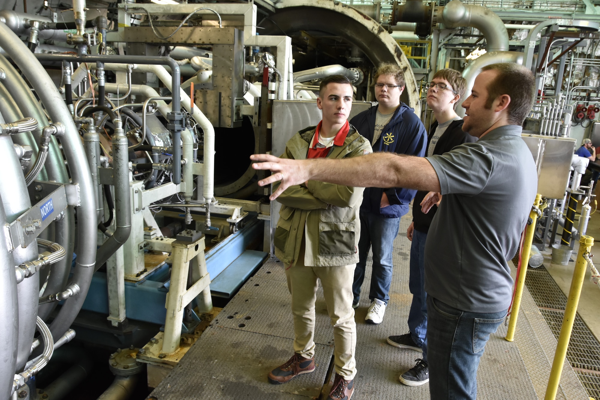 Arnold Air Force Base Aerospace Engineer Kevin Holst (right) describes the operation of the Aerodynamic and Propulsion Test Unit to Kaleb Smith (from left), Tim Barlow and Kendall Purdom. The local students were invited to participate in Engineer-for-a-Day on Feb. 21, 2018, as part of the Arnold AFB Engineers Week. (U.S. Air Force photo by Rick Goodfriend)