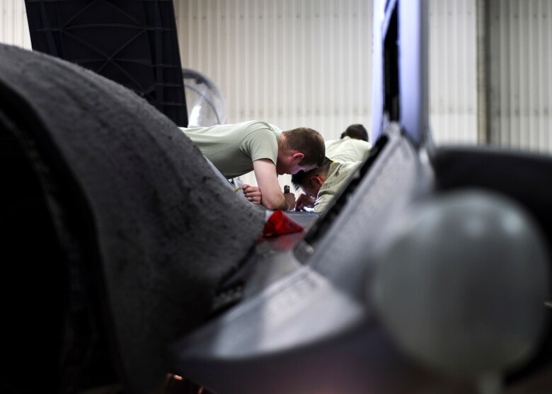 48th Maintenance Group maintainers work on the top of an F-15E Strike Eagle during a phase inspection at Royal Air Force Lakenheath, England, Jan. 10, 2019. The nine-day-long inspection is conducted by Airmen from several squadrons within the 48th MXG. (U.S. Air Force photo by Senior Airman Malcolm Mayfield)