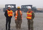 Robert Helgeson (left), U.S. Central Command’s deputy director for logistics and engineering, listens as LaTanya Callahan (center), area manager, and Navy Cmdr. Max Becker, officer in charge of DLA Disposition Services in Afghanistan, explain yard operations.