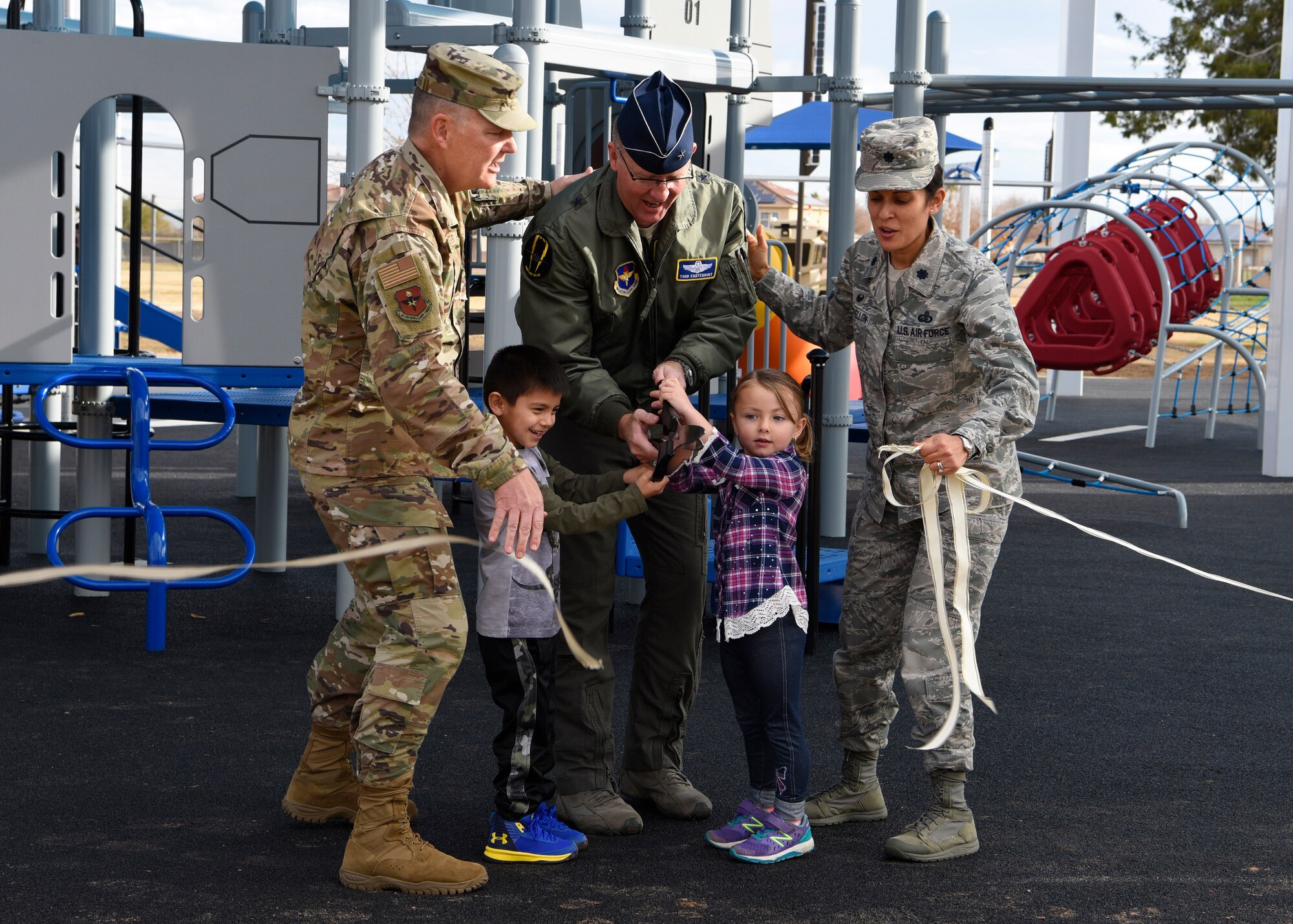 Leadership from the 56th Fighter Wing participate in a ribbon cutting ceremony, officially opening a new playground at Fowler Park, Jan. 9, 2019, at Luke Air Force Base, Ariz.