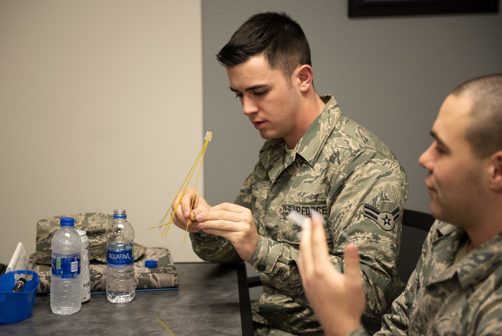 Airman 1st Class Dallas Ketcham, left, 60th Maintenance Squadron fuels systems apprentice, works with Airman Brandon Mc Entire, 60th MXS Precision Measurements and Equipment laboratory apprentice, during a competition with the First Term Airman Course class Jan. 10, 2019, at Travis Air Force Base, Calif. Airmen attend FTAC to help transition from the technical training atmosphere to the operational Air Force. (U.S. Air Force photo by Airman 1st Class Jonathon Carnell)
