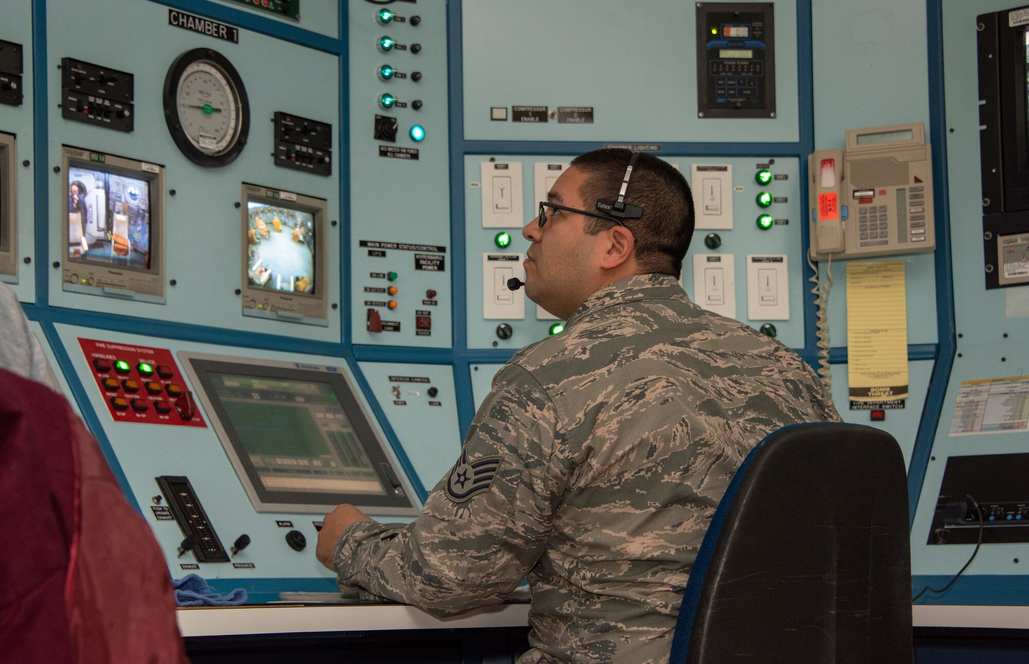 Staff Sgt. Corona Guerarzo, 60th Medical Group Hyperbaric Medicine Flight technician, monitors patients receiving hyperbaric oxygen therapy treatment, Dec. 8, 2019, at David Grant USAF Medical Center, Travis Air Force Base, California. The hyperbaric oxygen treatment chamber uses state-of-the-art technology to aid patients who are in need of therapy for a multitude of diagnosed illnesses. HBOT provides the application of 100 percent oxygen, proven to increase blood flow and promote cell growth and new blood vessel formation. (U.S. Air Force Photo by Heide Couch)