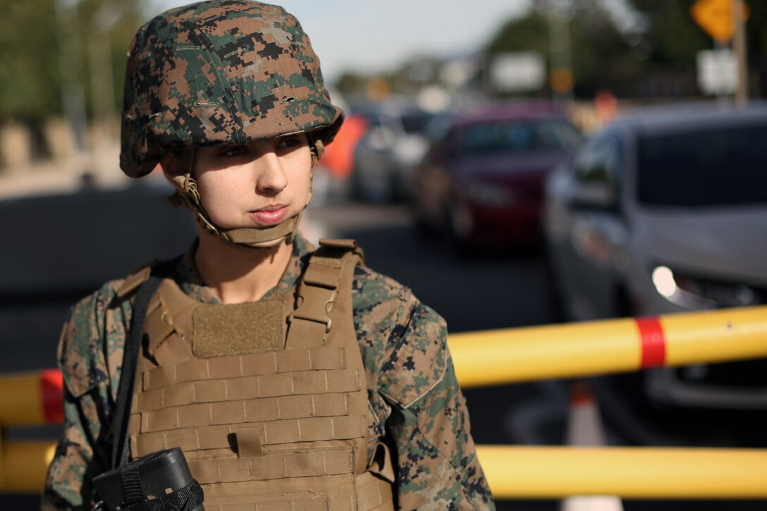 Lance Cpl. Britani Baker, a Security Augmentation Force (SAF) Marine at Marine Corps Air Station Miramar, blocks incoming traffic during a base lockdown drill at MCAS Miramar, Calif., Jan. 8. MCAS Miramar’s Provost Marshall’s Office and the SAF conduct routine base lockdown drills to rehearse, review and improve security procedures on the installation. (U.S. Marine Corps photo by Sgt. Jake M.T. McClung)
