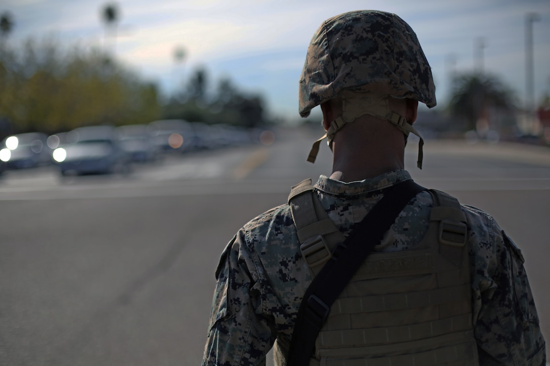 Lance Cpl. Jalen Frazier, a Security Augmentation Force (SAF) Marine at Marine Corps Air Station Miramar, stops traffic at a four way stop during a base lockdown drill at MCAS Miramar, Calif., Jan. 8. MCAS Miramar’s Provost Marshall’s Office and the SAF conduct routine base lockdown drills to rehearse, review and improve security procedures on the installation. (U.S. Marine Corps photo by Sgt. Jake M.T. McClung)