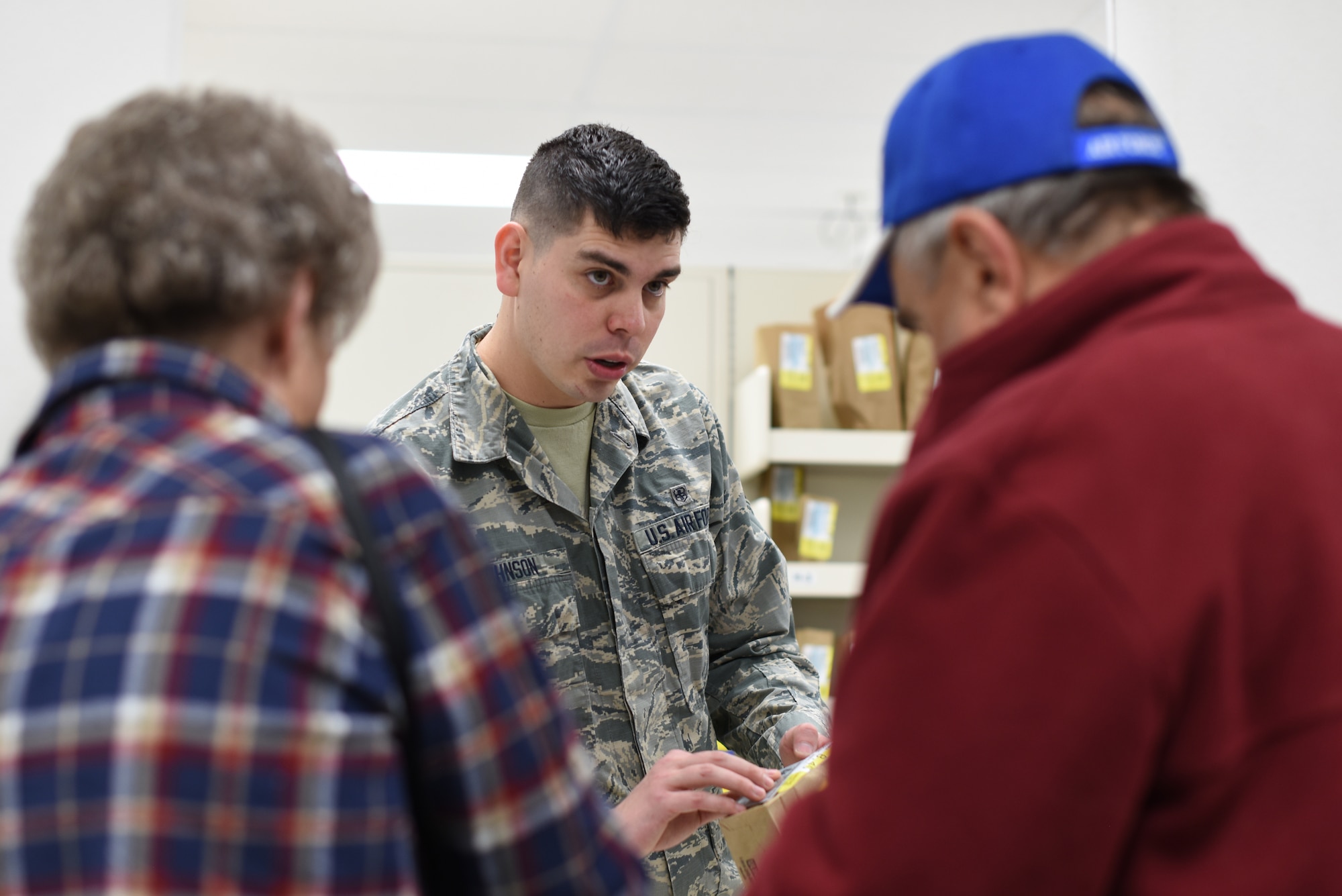 U.S. Air Force Airman 1st Class Tyler Johnson, 377th Medical Support Squadron pharmacy technician, assists patients at the Base Exchange Pharmacy at Kirtland Air Force Base, N.M., Jan. 8, 2019. In 2018, the 377th MDSS Pharmacy Flight filled over 215,000 prescriptions. (U.S. Air Force photo by Senior Airman Eli Chevalier)