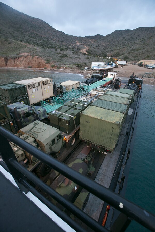 CATALINA ISLAND, Calif. – Marines with Marine Wing Support Squadron (MWSS) 373, Marine Wing Support Group (MWSG) 37, 3rd Marine Aircraft Wing, unload equipment from a barge at Catalina Island, Calif., Dec. 17. Marines unloaded utility and engineer assets to start the “Airport in the Sky” reconstruction project. Marines used the  reconstruction of the airport runway as training methods of expeditionary concrete repair, airfield damage, and mobile power generation, horizontal and vertical construction for combat engineers and heavy equipment operators. (U.S. Marine Corps photo by Lance Cpl. Juan Anaya)