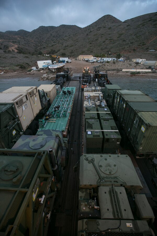 CATALINA ISLAND, Calif. – Marines with Marine Wing Support Squadron (MWSS) 373, Marine Wing Support Group (MWSG) 37, 3rd Marine Aircraft Wing, unload equipment from a barge at Catalina Island, Calif., Dec. 17. Marines unloaded utility and engineer assets as part of the “Airport in the Sky” air strip reconstruction project. Marines used the reconstruction of the airport runway as training methods of expeditionary concrete repair, airfield damage, and mobile power generation, horizontal and vertical construction for combat engineers and heavy equipment operators. (U.S. Marine Corps photo by Lance Cpl. Juan Anaya)