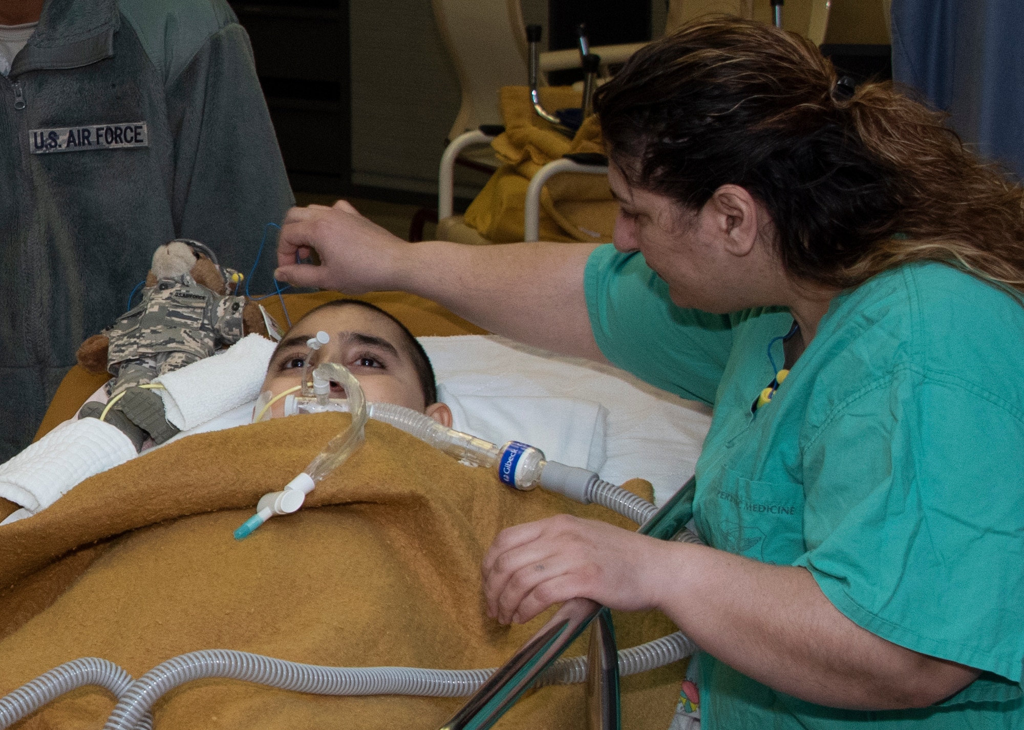 Anush Harutyunyan attends to her son, Jeremiah, 11, following his 13th treatment, Dec. 8, 2019. at David Grant USAF Medical Center, Travis Air Force Base, California.  Jeremiah is scheduled to receive a total of 30 hyperbric oxygen therapy treatments in an effort to halt or slow the rate of damage to his brain. (U.S. Air Force Photo by Heide Couch)