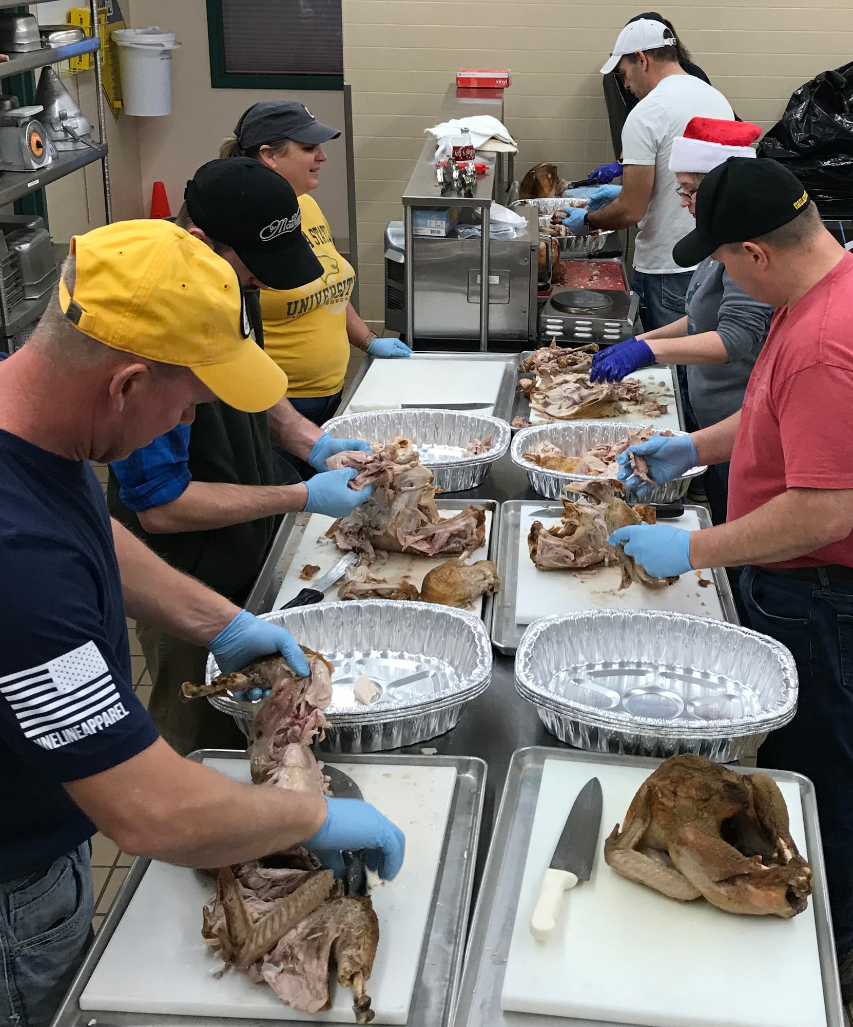 GREAT FALLS, Mont. -- Current and retired members of the 120th Airlift Wing, Montana Air National Guard, carve turkeys Dec. 24, 2018 at the MTANG dining facility here. More than 50 volunteers showed up, many before 5 a.m., to prepare food for the 26th annual Danny Berg Memorial Dinner, held on Christmas at the Great Falls Senior Center. This was the 17th year MTANG has been a partner in this charitable event. Airmen roasted 60 turkeys, cooked stuffing and made more than 40 gallons of gravy. At the end of the day almost 600 meals were served. “This is one of the highlights of the year,” said Master Sgt. Robert Osier, 120th AW Base Services Manager. “It’s great to make a difference and to truly give back to the community.” The holiday meal is named for Retired Master Sgt. Danny Berg, a former member of the 120th AW who established the event for local residents who may not have family or friends to spend the holiday with. Berg passed away in 2008 after battling cancer. (U.S. Air National Guard photo/Master Sgt. Robert Osier)
