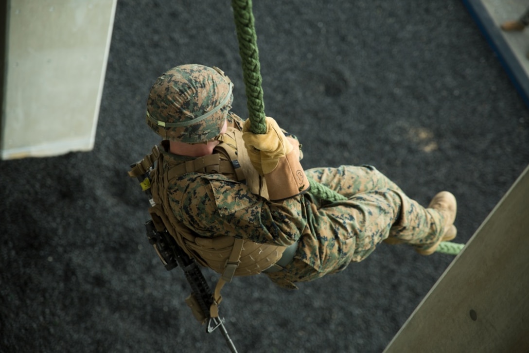 A Marine with Weapons Company, Battalion Landing Team, 1st Battalion, 4th Marines, slides down a rope during training at Camp Schwab, Okinawa, Japan, Jan. 7, 2019. Fast roping allows Marines to quickly enter otherwise inaccessible locations from hovering aircraft. BLT 1/4 is the Ground Command Element for the 31st Marine Expeditionary Unit. The 31st Marine Expeditionary Unit, the Marine Corps’ only continuously forward-deployed MEU, provides a flexible and lethal force ready to perform a wide range of military operations as the premier crisis response force in the Indo-Pacific region. (Official Marine Corps photo by Cpl. Luis Velez/ Released)