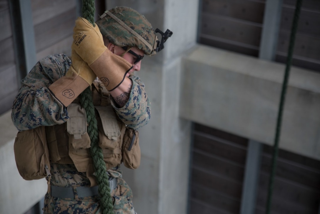 Cpl. Michael J. Wurster, a radio operator with Weapons Company, Battalion Landing Team, 1st Battalion, 4th Marines, slides down a rope during fast rope training at Camp Schwab, Okinawa, Japan, Jan. 7, 2019. Fast roping allows Marines to quickly enter otherwise inaccessible locations from hovering aircraft. BLT 1/4 is the Ground Combat Element for the 31st Marine Expeditionary Unit. The 31st MEU, the Marine Corps’ only continuously forward-deployed MEU, provides a flexible and lethal force ready to perform a wide range of military operations as the premier crisis response force in the Indo-Pacific Region. (U.S. Marine Corps photo by Lance Cpl. Kyle P. Bunyi/ Released)