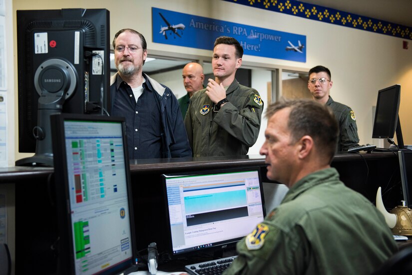 Instructors and students review training video.