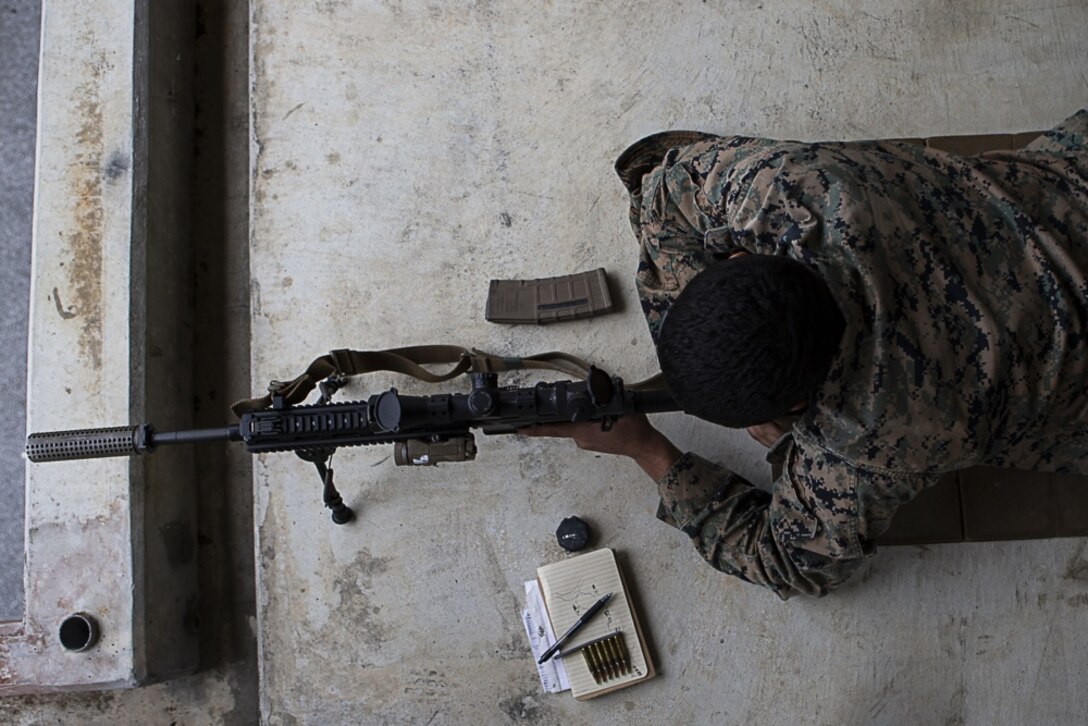 Lance Cpl. Martin Roslies, a designated marksman and rifleman with Charlie Company, Battalion Landing Team, 1st Battalion, 4th Marines, identifies targets during training at Camp Hansen, Okinawa, Japan, Jan. 9, 2019. Roslies, a native of Yuba City, California, graduated from Henley High School in Klamath Falls, Oregon before enlisting in June 2015. Designated marksmen and machine gunners with Charlie Company fired more than 13,000 rounds during the training, refining their abilities with the M240B medium machine gun and M38 designated marksmen rifle as part of BLT 1/4, the Ground Combat Element for the 31st Marine Expeditionary Unit. The 31st MEU, the Marine Corps’ only continuously forward-deployed MEU, provides a flexible and lethal force ready to perform a wide range of military operations as the premier crisis response force in the Indo-Pacific region. (U.S. Marine Corps photo by Gunnery Sgt. T. T. Parish/Released)