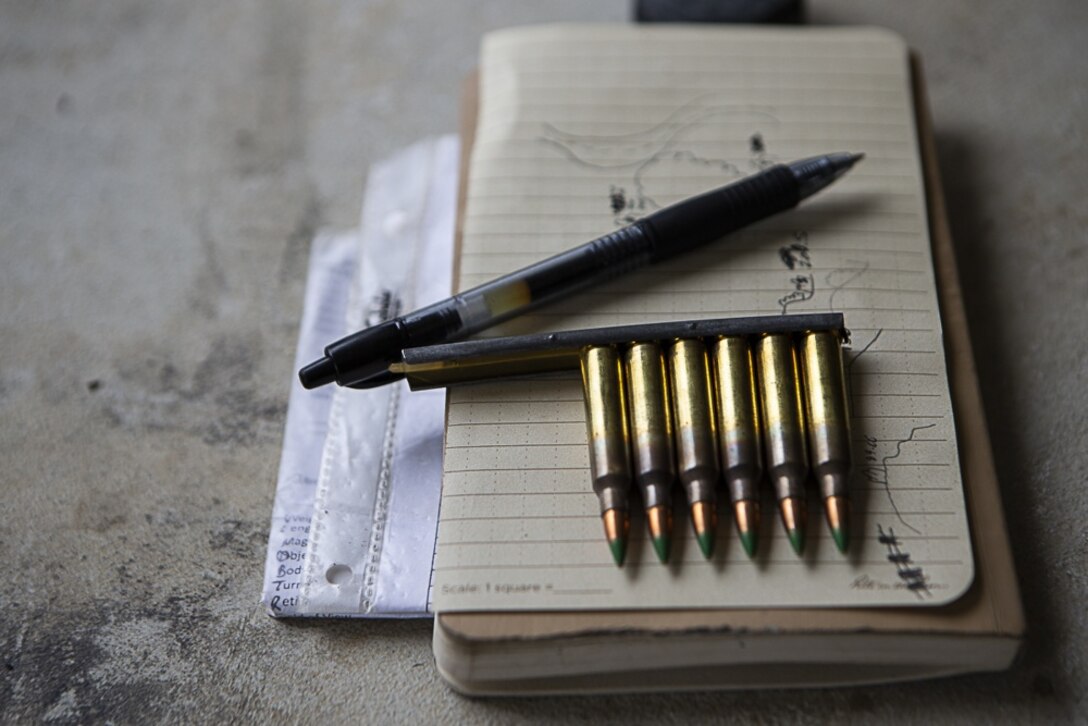 A sketch map and 5.56 mm rounds sit ready for use by Lance Cpl. Martin Roslies, a designated marksman and rifleman with Charlie Company, Battalion Landing Team, 1st Battalion, 4th Marines, during training at Camp Hansen, Okinawa, Japan, Jan. 9, 2019. Roslies, a native of Yuba City, California, graduated from Henley High School in Klamath Falls, Oregon before enlisting in June 2015. Designated marksmen and machine gunners with Charlie Company fired more than 13,000 rounds during the training, refining their abilities with the M240B medium machine gun and M38 designated marksmen rifle as part of BLT 1/4, the Ground Combat Element for the 31st Marine Expeditionary Unit. The 31st MEU, the Marine Corps’ only continuously forward-deployed MEU, provides a flexible and lethal force ready to perform a wide range of military operations as the premier crisis response force in the Indo-Pacific region. (U.S. Marine Corps photo by Gunnery Sgt. T. T. Parish/Released)