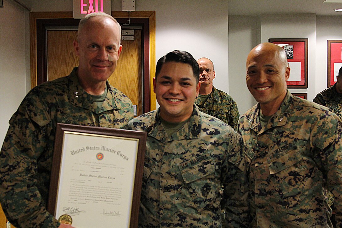 CAMP HUMPHREYS, Republic of Korea –Gunnery Sgt. Jerry Pershin (center), U.S. Marine Corps Forces Korea G-3 spectrum manager, receives his promotion warrant from Maj. Gen. Patrick J. Hermesmann (left), MARFORK commander, Jan. 11.  Pershin asked Lt. Col. Cedric Lee (right), MARFORK G-6 assistant chief of staff, to pin on his new rank, which he earned after more than 13 years of faithful service. (Official U.S. Marine Corps photo by Sgt. Nathaniel Hanscom/released)