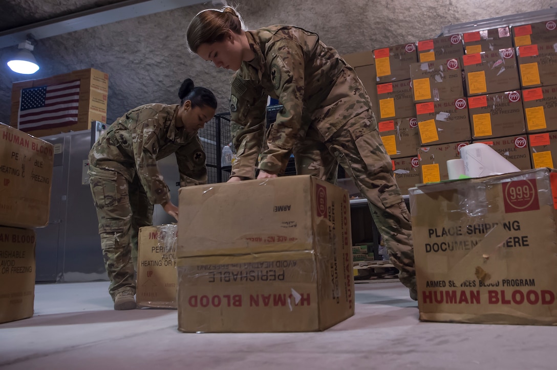 Staff Sgt. Jasmine Gates, left, and Staff Sgt. Alexis Ellingson, both 379th Expeditionary Aeromedical Evacuation Squadron aeromedical evacuation technicians, check boxes used for transporting blood for defects in the Blood Transshipment Center (BTC) Jan. 9, 2019, at Al Udeid Air Base Qatar. Ellingson and Gates volunteered time to assist Airmen at the BTC in preparing blood products for transport. The BTC is comprised of a four-person team that orchestrates the flow of blood and platelet products to 72 forward operating locations and eight mobile field surgical teams throughout U.S. Central Command’s area of responsibility. (U.S. Air Force by Tech. Sgt. Christopher Hubenthal)