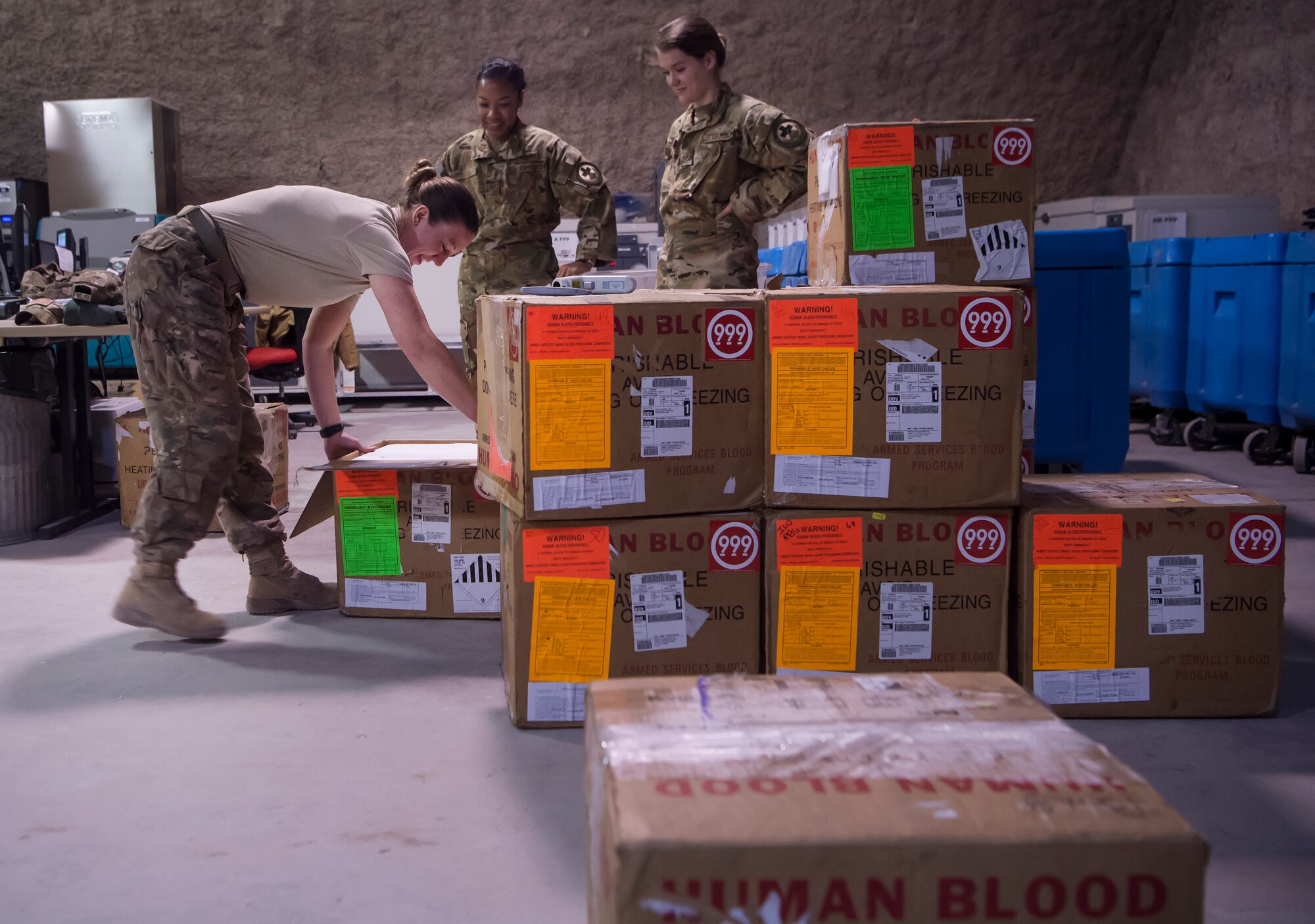 Staff Sgt. Jessica Kinser, left, 379th Expeditionary Medical Group Blood Transshipment Center (BTC) lab technician, shows Staff Sgt. Jasmine Gates (center) and Staff Sgt. Alexis Ellingson, both 379th Expeditionary Aeromedical Evacuation Squadron aeromedical evacuation technicians, how to process blood for storage at the BTC Jan. 9, 2019, at Al Udeid Air Base, Qatar. Ellingson and Gates volunteered to prepare blood products for transport at the BTC. The BTC is comprised of a four-person team that orchestrates the flow of blood and platelet products to 72 forward operating locations and eight mobile field surgical teams throughout U.S. Central Command’s area of responsibility. (U.S. Air Force by Tech. Sgt. Christopher Hubenthal)