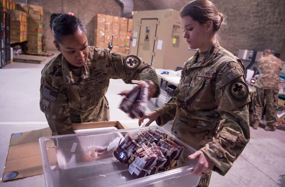 Staff Sgt. Jasmine Gates, left, and Staff Sgt. Alexis Ellingson, right, both 379th Expeditionary Aeromedical Evacuation Squadron aeromedical evacuation technicians, inventory and store a shipment of blood in the Blood Transshipment Center (BTC) Jan. 9, 2019, at Al Udeid Air Base, Qatar. Ellingson and Gates volunteered to prepare blood products for transport at the BTC. The BTC is comprised of a four-person team that orchestrates the flow of blood and platelet products to 72 forward operating locations and eight mobile field surgical teams throughout U.S. Central Command’s area of responsibility. (U.S. Air Force by Tech. Sgt. Christopher Hubenthal)