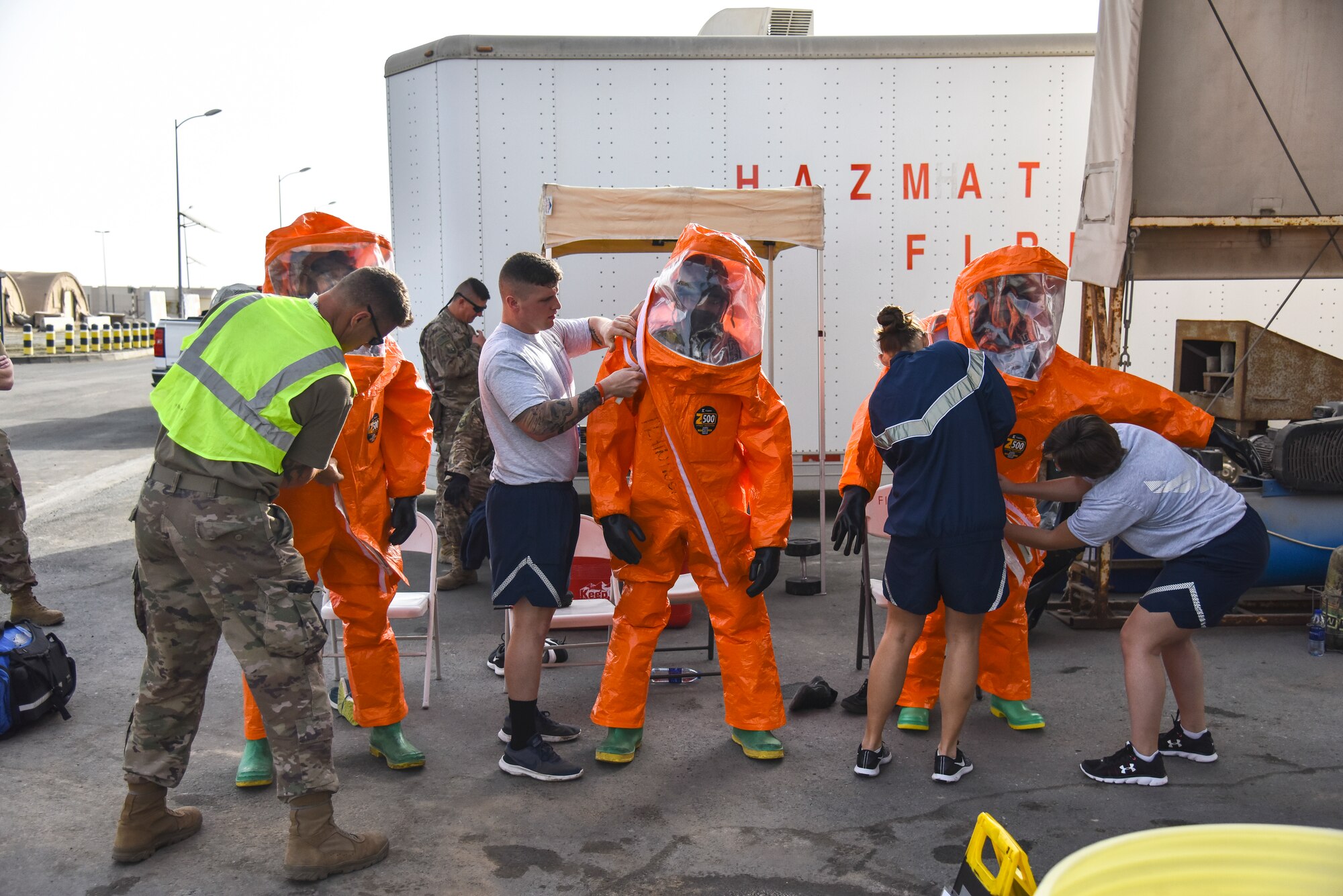 U.S. Airmen assigned to the 380th Expeditionary Civil Engineer Squadron don Level-A suits during a hazardous materials exercise at Al Dhafra Air Base, United Arab Emirates, Jan. 4, 2019. The 380th ECES Fire Department and Emergency Management flights conducted a joint-agency hazardous material exercise for training purposes. (U.S. Air Force photo by Senior Airman Mya M. Crosby)