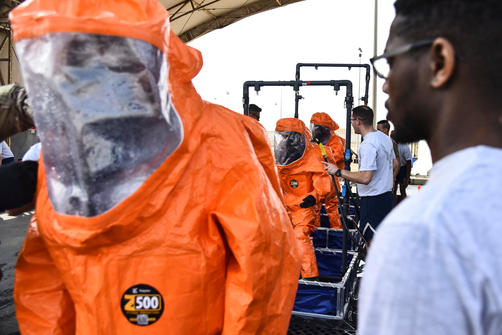 U.S. Airmen assigned to the 380th Expeditionary Civil Engineer Squadron Fire Department process through a technical decontamination during a hazardous materials exercise at Al Dhafra Air Base, United Arab Emirates, Jan. 4, 2019. The 380th ECES Fire Department and Emergency Management flights conducted a joint-agency hazardous material exercise for training purposes. (U.S. Air Force photo by Senior Airman Mya M. Crosby)