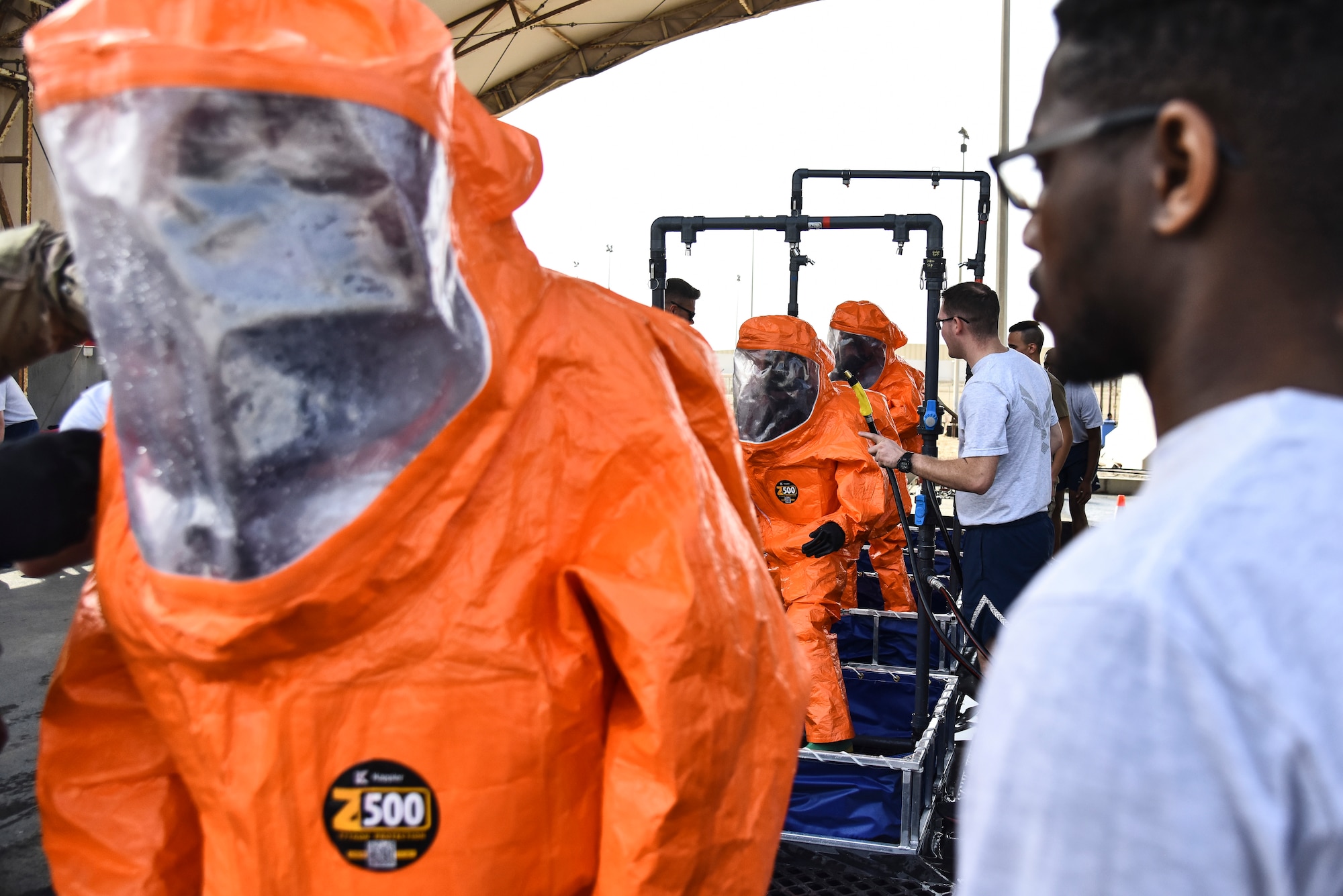 U.S. Airmen assigned to the 380th Expeditionary Civil Engineer Squadron Fire Department process through a technical decontamination during a hazardous materials exercise at Al Dhafra Air Base, United Arab Emirates, Jan. 4, 2019. The 380th ECES Fire Department and Emergency Management flights conducted a joint-agency hazardous material exercise for training purposes. (U.S. Air Force photo by Senior Airman Mya M. Crosby)