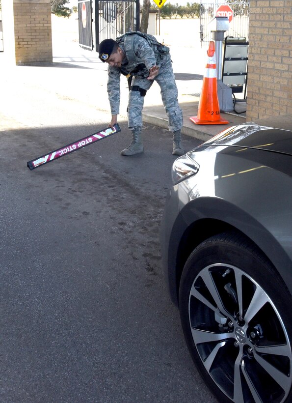 Amn. First Class Ismael Khan, with the 72nd Security Forces Squadron, uses a stop stick at the Tinker Gate to halt traffic in certain situations. The stop sticks should not be run over by a vehicle, as they can potentially cause damage to either the vehicle or the stick itself.