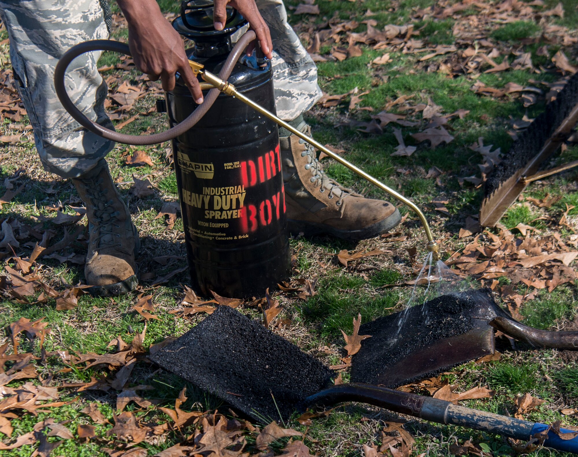 The 20th Civil Engineer Squadron Airmen, also known as the Dirt Boyz, spray shovels, equipment and their shoes with asphalt remover at Shaw Air Force Base, S.C., Jan. 8, 2019.