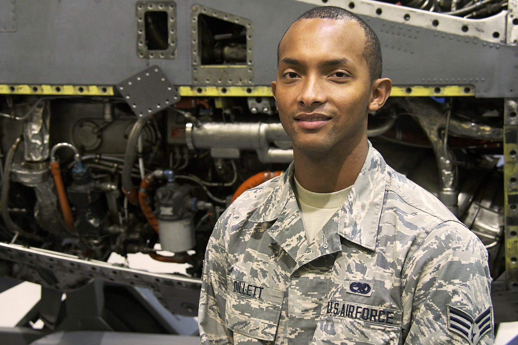 Senior Airman Damian Dillett, a 94th Aircraft Maintenance Squadron aircraft engine technician, poses for a photo in a maintenance hangar at Dobbins Air Reserve Base, Ga. Dec. 9, 2018. Dillett recently graduated from the Cobb County Police Academy in Georgia. (U.S. Air Force photo/Staff Sgt. Andrew Park)