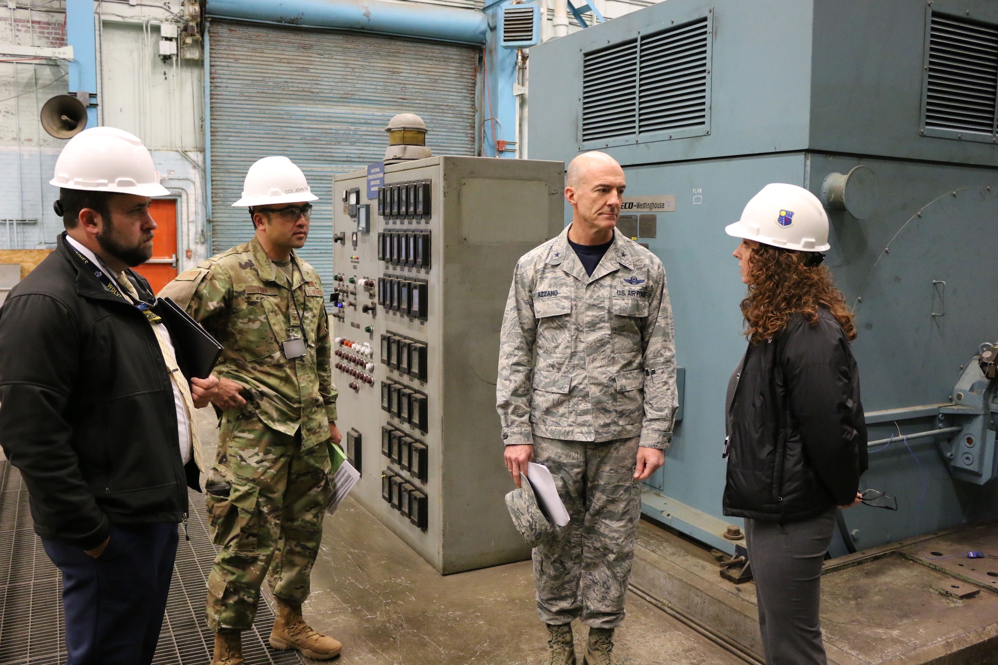 Brig. Gen. Christopher Azzano, commander of the Air Force Test Center, second from right, receives an update on upcoming Service Life Extension Program projects at AEDC from TSS Capital Improvements Lead Engineer and SLEP Manager Kathleen Bajar, right. Also pictured are TSS Capital Improvements Technical Advisor Josh Meeks, left, AEDC Test Systems Sustainment Chief Col. John Tran. Azzano and other AFTC leadership visited Arnold Air Force Base in mid-November to take part in the 2018 AFTC Strategic Offsite, Azzano’s first offsite since assuming the role of AFTC commander in August. (U.S. Air Force photo by Brad Hicks) (This image was altered by obscuring badges for security purposes)