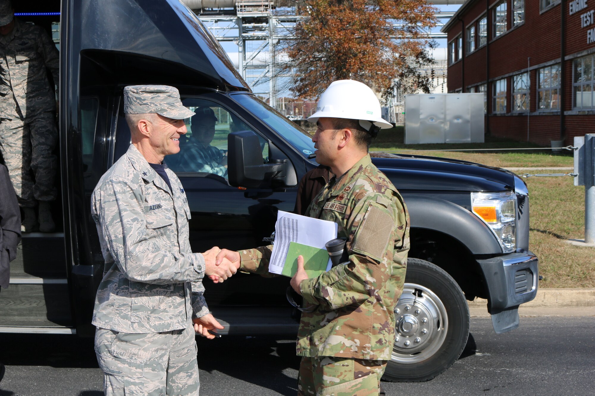 Brig. Gen. Christopher Azzano, commander of the Air Force Test Center, left, is greeted by AEDC Test Systems Sustainment Chief Col. John Tran outside of the Engine Test Facility at Arnold Air Force Base. Azzano and other AFTC leadership visited Arnold Air Force Base in mid-November to take part in the 2018 AFTC Strategic Offsite, Azzano’s first offsite since assuming the role of AFTC commander in August. (U.S. Air Force photo by Brad Hicks) (This image was altered by obscuring badges for security purposes)