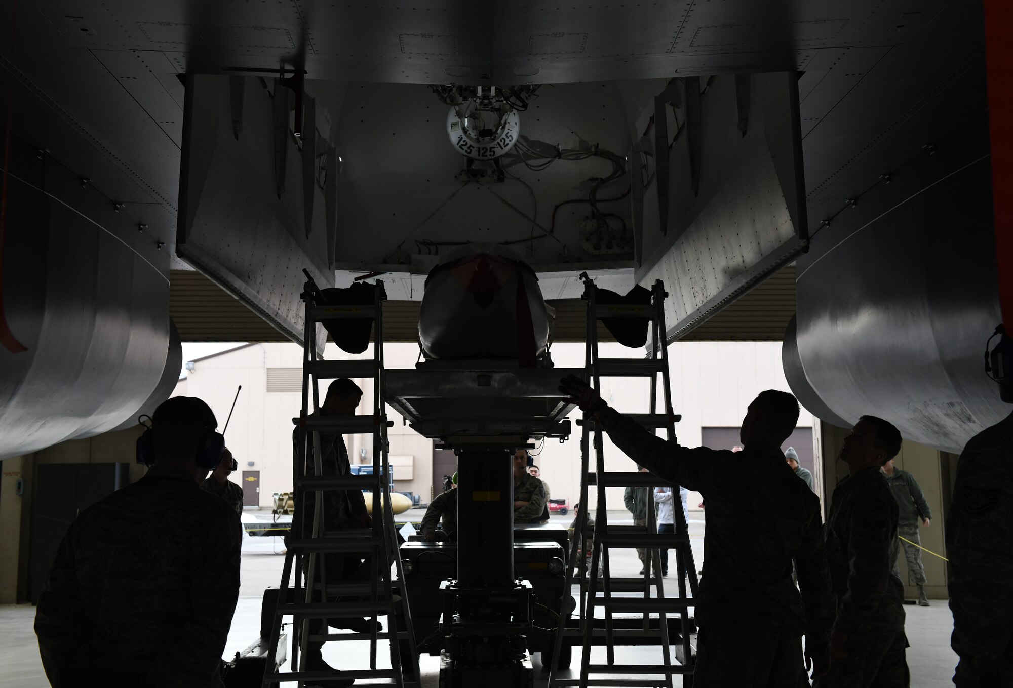Load Crew Members assigned to the 34th Aircraft Maintenance Unit prepare to load an inert AGM-158 Joint Air-to-Surface Standoff Missile into a simulated B-1 Bomber at the annual weapons loading competition at Ellsworth Air Force Base, S.D., Jan. 7, 2019. The JASSM weighs 2,250 pounds and has to be lifted approximately 17 feet in the air to be inserted into the bomb bay of the simulated B-1 bomber. (U.S. Air Force photo by Airman 1st Class Christina Bennett)