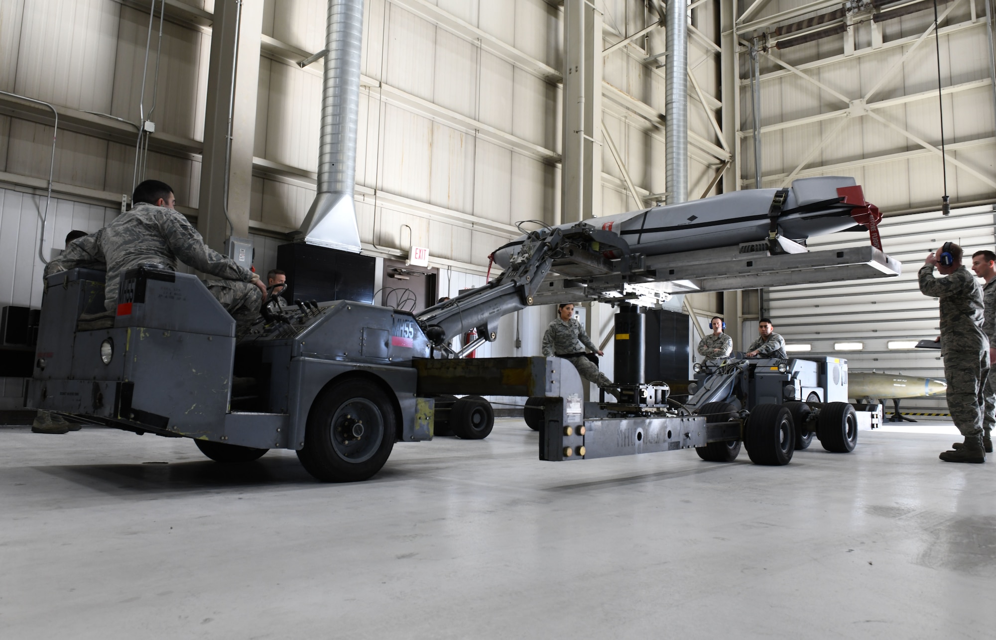 Load crew members from the 28th Munitions Squadron use a munitions lift truck or ‘jammer’, to load an inert AGM-158 Joint Air-to-Surface Standoff Missile into a simulated B-1 bomber at the annual weapons load competition at Ellsworth Air Force Base, S.D., Jan. 7, 2019. Each team was required to complete the loading process within 40 minutes and were also graded on proficiency, technique and safety. (U.S. Air Force photo by Airman 1st Class Christina Bennett)