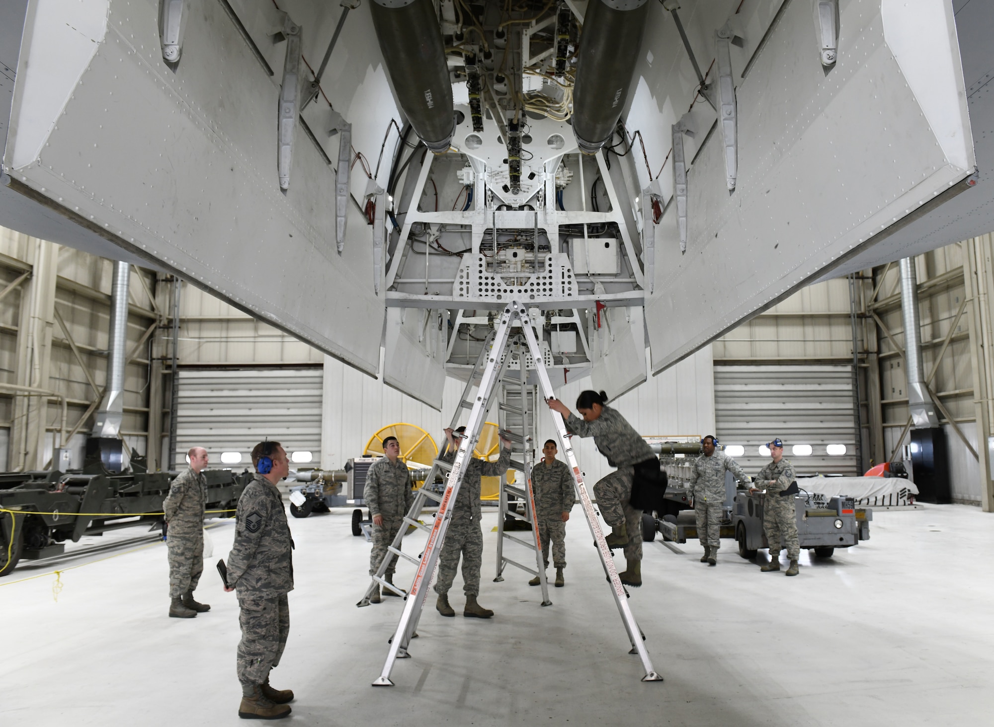 The load crew team from the 28th Munitions Squadron inspect their work after loading two inert GBU-38 Joint Direct Attack Munitions and one inert AGM-158 Joint Air-to-Surface Standoff Missile onto a simulated B-1 bomber during the annual weapons load competition at Ellsworth Air Force Base, S.D., Jan. 7, 2019. The winning team of the annual competition is announced at the Maintenance Professional of the Year awards banquet. (U.S. Air Force photo by Airman 1st Class Christina Bennett)