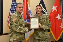 Col. Timothy G. Dalton receives his charter as the incoming U.S. Army Training and Doctrine Command Capabilities Manager for Space and High Altitude, from Lt. Gen. James H. Dickinson, commanding general, U.S. Army Space and Missile Defense Command/Army Forces Strategic Command, during a Jan. 4, 2019, Change of Charter at the command's headquarters on Redstone Arsenal, Alabama. The TCM SHA belongs to SMDC's Future Warfare Center but receives operational authority through TRADOC's four-star general. (U.S. Army photo by Ronald Bailey)