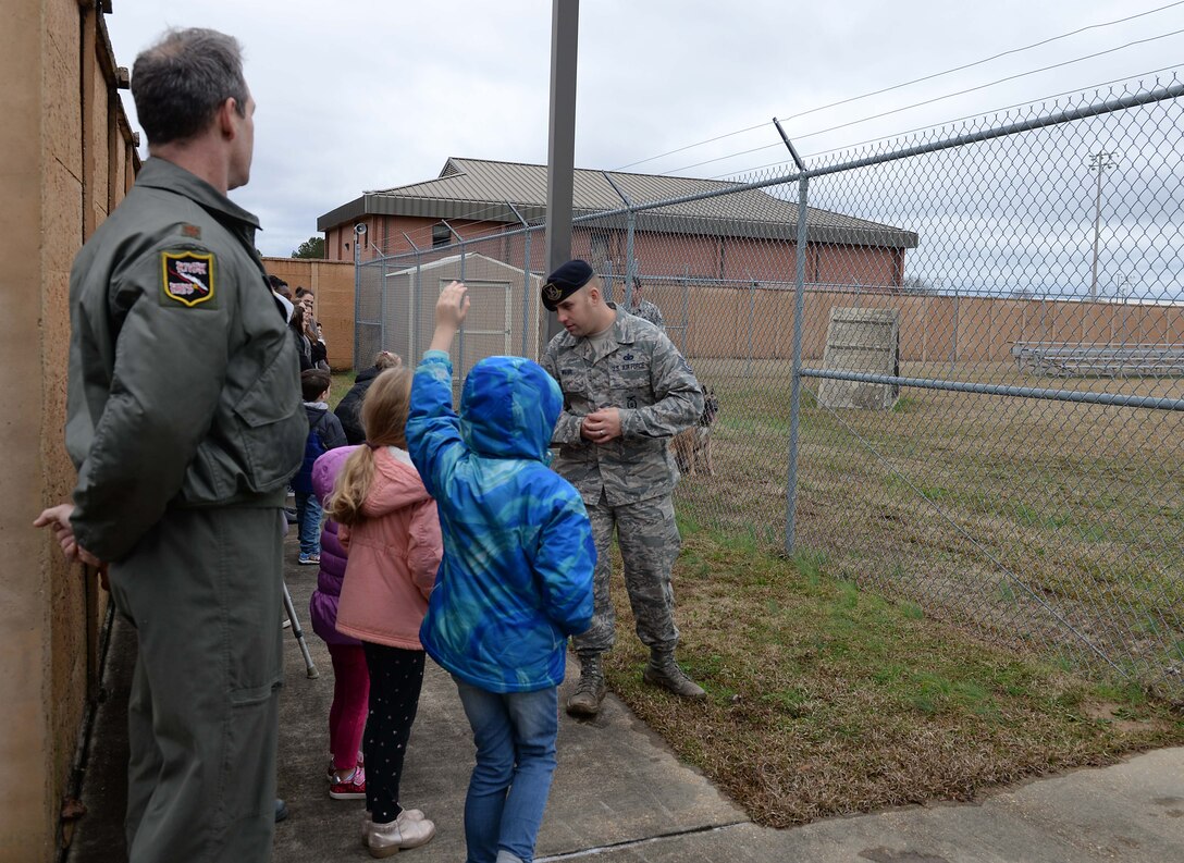 Tech. Sgt. Bruce Weir, 14th Security Forces Squadron military working dog trainer, answers questions during a MWD demonstration, Jan. 4, 2019, at the MWD kennel on Columbus Air Force Base, Mississippi. The visitors explored many aspects of Columbus AFB including static displays, time in flight simulators and much more. (U.S. Air Force photo by Airman Hannah Bean)