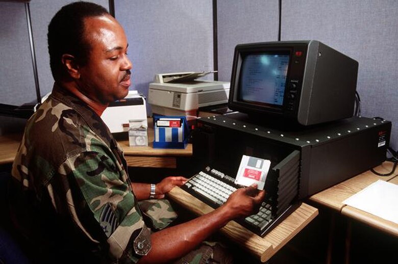 Master Sgt. Gregory E. Settles uses a UKY-83 desktop computer in the combat communications center to convey information to the United States Central Command Area of Operation from Langley AFB, Virginia, 8 Jan 1992. 
(Courtesy of the AFNIC History Office)