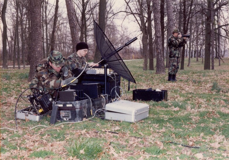 Two AFC4A Hammer ACE team members setting up the LSSC-300 terminal and portable satellite antenna during a training exercise at Scott AFB during the 1990s. 
(Courtesy of the AFNIC History Office)
