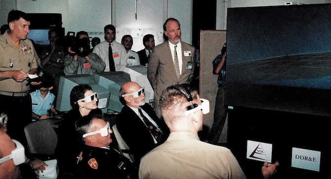 Viewing one of the 3-D displays during JWID97 execution is General Malchase D. Shalikashvili, Chairman of the Joint Chiefs of Staff and General John J. Sheehan, Supreme Allied Command Atlantic, NATO, 1997. 
(Courtesy of the Mr. Thomas P. Korte)